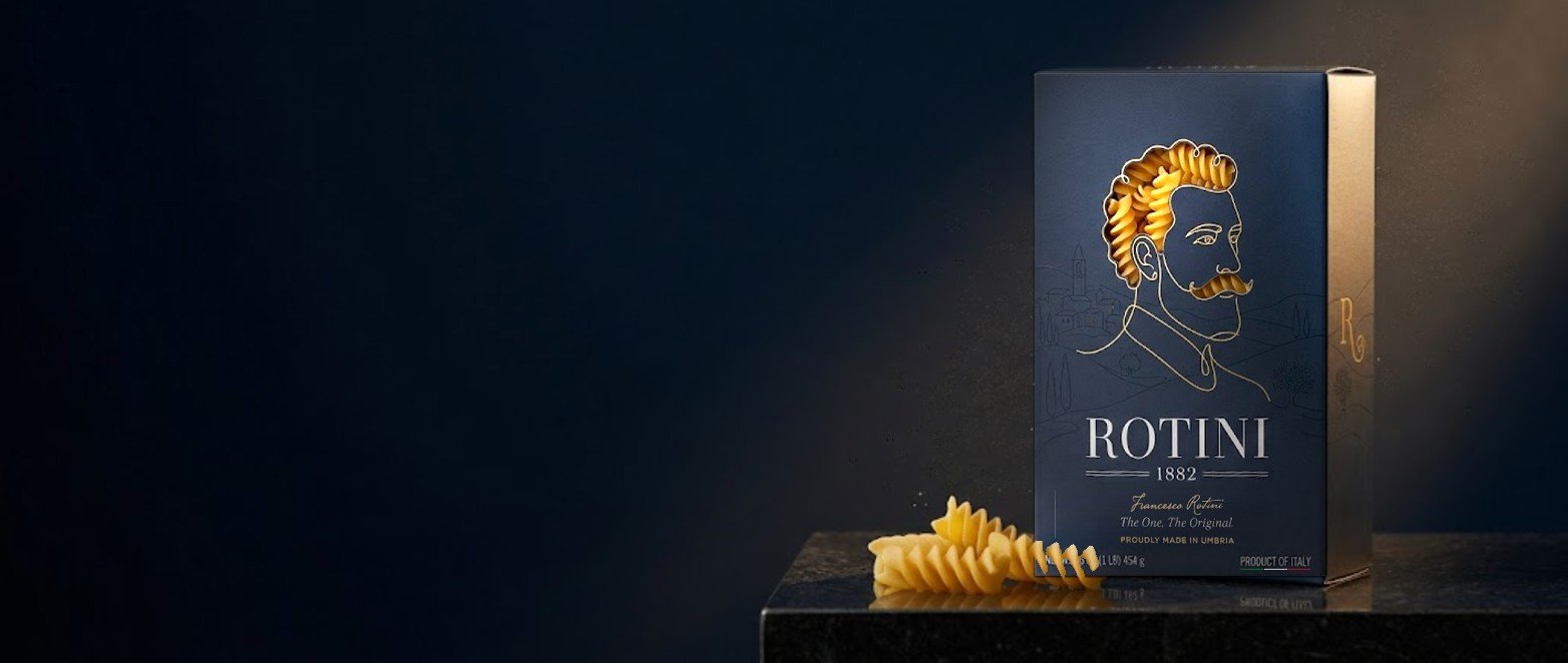 The Rotini 1882 box on travertine stone with a linen napkin and giant fusilloni